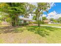 Charming home with green lawn, beautiful foliage, and a cozy, welcoming feel at 3120 Mango Tree Dr, Edgewater, FL 32141
