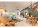 Bright living room with tile floors, ceiling fan, and large windows for natural light at 3120 Mango Tree Dr, Edgewater, FL 32141