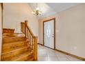 Entryway with wood stairs, a white door, and tiled flooring with an overhead light at 3222 Juniper Dr, Edgewater, FL 32141