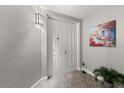 Entryway featuring a white door, neutral walls with decorations, and tile flooring at 3245 S Atlantic Ave # 208, Daytona Beach, FL 32118