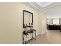 Bright hallway with decorative table, mirror and glimpses of the living room at 3245 S Atlantic Ave # 208, Daytona Beach, FL 32118
