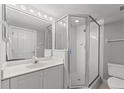 Bright bathroom with a vanity and mirror, and a shower with a glass door for a modern look at 3425 S Atlantic Ave # 902, Daytona Beach, FL 32118
