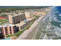 Aerial view of beachfront condos offering direct access to the sandy beach and stunning ocean views at 4139 S Atlantic Ave # A302, New Smyrna Beach, FL 32169