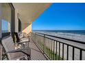Relax on this condo balcony with comfortable seating and panoramic views of the ocean and the sandy beach at 4139 S Atlantic Ave # A302, New Smyrna Beach, FL 32169
