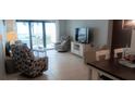 Bright living room featuring tile floors, ceiling fan and comfortable seating arrangements at 4175 S Atlantic Ave # 2280, New Smyrna Beach, FL 32169