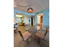 Cozy dining area featuring a glass table, four chairs, and unique lighting at 421 S Atlantic Ave # 407, New Smyrna Beach, FL 32169