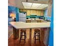 Bright kitchen with lots of counter space with bar and stools at 421 S Atlantic Ave # 407, New Smyrna Beach, FL 32169