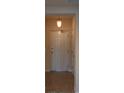 Entryway featuring a sturdy white front door with tile flooring and a decorative hanging light fixture at 424 Luna Bella Ln # 316, New Smyrna Beach, FL 32168