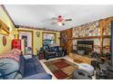 Cozy living room with a stone fireplace and wood-paneled accent wall at 428 Perdita Ave, Edgewater, FL 32132