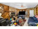Inviting living room with a stone fireplace and tile flooring at 428 Perdita Ave, Edgewater, FL 32132
