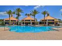 Large community pool with three covered lounge areas, offering ample seating and shade at 4620 Riverwalk Village Ct # 7306, Ponce Inlet, FL 32127