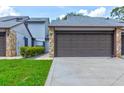 Charming townhome featuring a private two-car garage, stone accents, and a well-maintained lawn at 488 Shorewood Ln, New Smyrna Beach, FL 32168