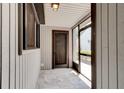 Inviting screened-in porch area, perfect for enjoying fresh air, with tile flooring and neutral walls at 488 Shorewood Ln, New Smyrna Beach, FL 32168
