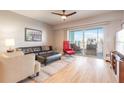 Bright living room with hardwood floors, neutral paint, comfortable seating and a sliding glass door to the balcony at 5300 S Atlantic Ave # 1-603, New Smyrna Beach, FL 32169