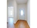 Bright foyer with wood-look flooring, leading to other areas of the home at 534 Stowers Dr, New Smyrna Beach, FL 32168