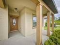 Covered front porch with decorative columns, offering a welcoming entrance to the home at 534 Stowers Dr, New Smyrna Beach, FL 32168
