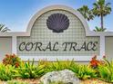 Attractive Coral Trace community sign with lush landscaping in a well maintained development at 535 Coral Trace Blvd, Edgewater, FL 32132