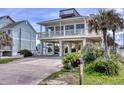 Inviting beach home featuring covered parking and a delightful widow's walk for panoramic vistas at 6320 S Atlantic Ave, New Smyrna Beach, FL 32169