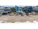Charming beach house with private beach access, steps leading down to the sandy shore and ocean at 6871 S Atlantic Ave., New Smyrna Beach, FL 32169