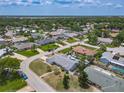 An aerial view reveals a charming neighborhood with mature trees, single-story homes, and serene streets at 7 Heather Ln, Ormond Beach, FL 32174