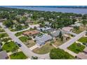 An aerial view displays homes in a beautiful neighborhood with mature trees near a body of water at 7 Heather Ln, Ormond Beach, FL 32174