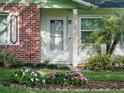 Close-up of front entrance with attractive landscaping, flower beds, and a charming, well-maintained entryway at 708 Egret Ct, Edgewater, FL 32141