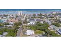 Picturesque aerial view of a charming neighborhood near the ocean with mature trees and well-maintained homes in close proximity at 833 E 12Th Ave, New Smyrna Beach, FL 32169