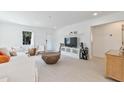 Modern living space boasts clean lines, natural light, entertainment center, and light wood accents for a stylish aesthetic at 833 E 12Th Ave, New Smyrna Beach, FL 32169