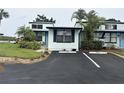 Inviting coastal townhome featuring black shutters, assigned parking and tidy front landscaping at 84 Heather Point Ct, New Smyrna Beach, FL 32169