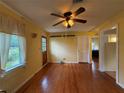 The living room has hardwood floors, a ceiling fan, and natural light from the window at 125 Rio Vista Dr, Edgewater, FL 32132
