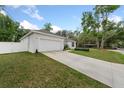 Long driveway leading to a two-car garage in a well-maintained suburban setting at 1290 9Th St, Orange City, FL 32763