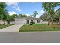 Inviting home with a well-kept lawn, charming curb appeal, and a serene neighborhood at 1290 9Th St, Orange City, FL 32763