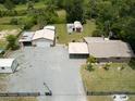 Aerial view of a home with multiple outbuildings and generous yard space at 130 N Gaines St, Oak Hill, FL 32759