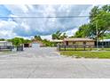 Spacious property with home, garages, and driveways offering ample space at 130 N Gaines St, Oak Hill, FL 32759