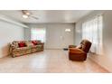 Cozy living room with tile flooring, comfortable seating, and natural light at 130 N Gaines St, Oak Hill, FL 32759