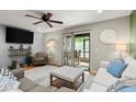 Cozy living room with neutral tones, plush seating, ceiling fan and sliding glass doors that leads to the patio at 140 Limewood Pl # C, Ormond Beach, FL 32174