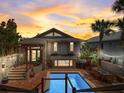Expansive backyard with a sparkling pool, dining area, and lush landscaping, ideal for entertaining at 1421 N Atlantic Ave, New Smyrna Beach, FL 32169