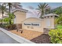 The Portofino Reserve entrance sign features lush landscaping in a well-maintained community at 150 Portofino Blvd, New Smyrna Beach, FL 32168