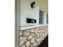 Close-up of stone exterior details with the house number and mailbox at 167 N Hill Ave # 60, Deland, FL 32724