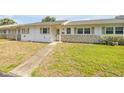 Bright and sunny single-story exterior with stone accents, neutral paint, and walkway at 167 N Hill Ave # 60, Deland, FL 32724