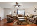 Comfortable living room showcasing hardwood floors, ceiling fan, and ample seating at 1723 Needle Palm Dr, Edgewater, FL 32132