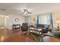 Cozy living room with hardwood floors, ceiling fan, and comfortable seating at 1723 Needle Palm Dr, Edgewater, FL 32132