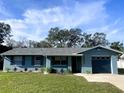 Attractive single-Gathering home with a lush green lawn, neat landscaping, and an attached single car garage at 1920 Travelers Palm Dr, Edgewater, FL 32141