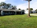 Quaint one-story home with a well-kept lawn and landscaping, adjacent to other houses in a quiet neighborhood at 1920 Travelers Palm Dr, Edgewater, FL 32141