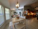 Bright and airy living space with tile floors, dining table, and a glimpse of the modern kitchen at 1941 Spruce Creek Lndg, Port Orange, FL 32128