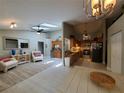 Inviting open floor plan with lots of light, showcasing seamless transitions between the living area and kitchen at 1941 Spruce Creek Lndg, Port Orange, FL 32128