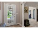 Bright foyer featuring tile flooring, a decorative column, and view of the front yard at 1983 Turnbull Lakes Dr, New Smyrna Beach, FL 32168