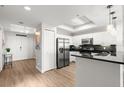 Well-lit kitchen with stainless steel appliances, granite countertops, and wood floors at 2 Oceans West Blvd # 702, Daytona Beach, FL 32118