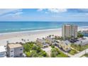 Beautiful aerial view of beachfront homes with lush landscaping and ocean views at 2101 Hill St, New Smyrna Beach, FL 32169