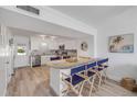 Bright kitchen with white cabinets, granite counters, stainless appliances, and a large island bar with seating at 2122 S Atlantic Ave # 2122, New Smyrna Beach, FL 32169
